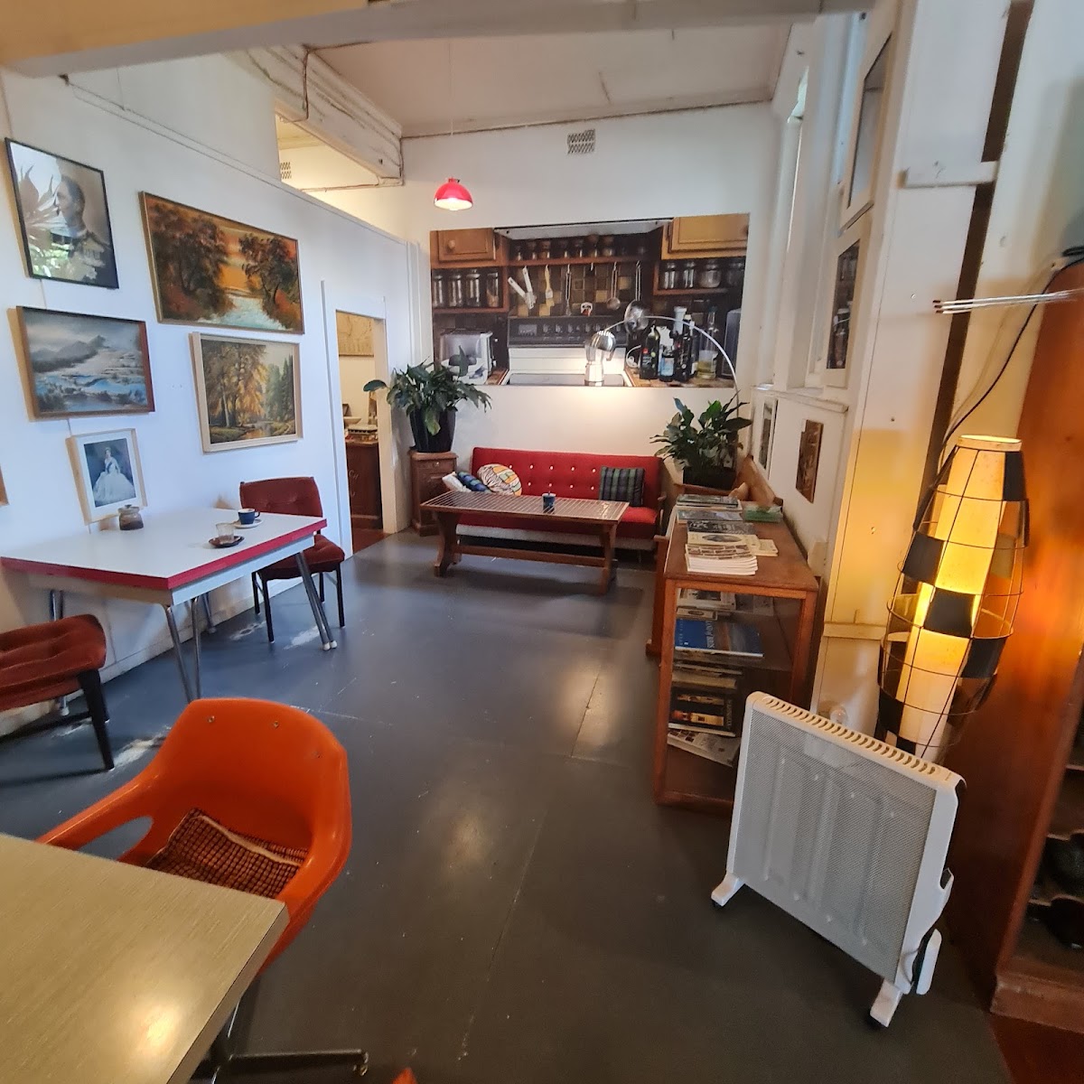 Vintage lounge corner with red sofa and paintings